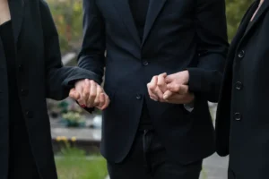 pessoas de mãos dadas em um momento de apoio ao luto